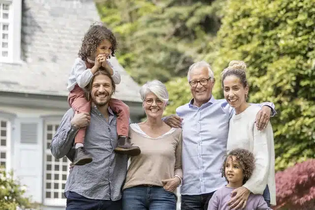 Happy family standing in the garden of the home protected by their living trust
