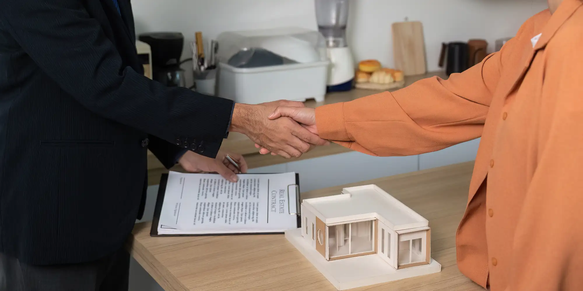 Buyer and seller shaking hands after a California mobile home ownership transfer
